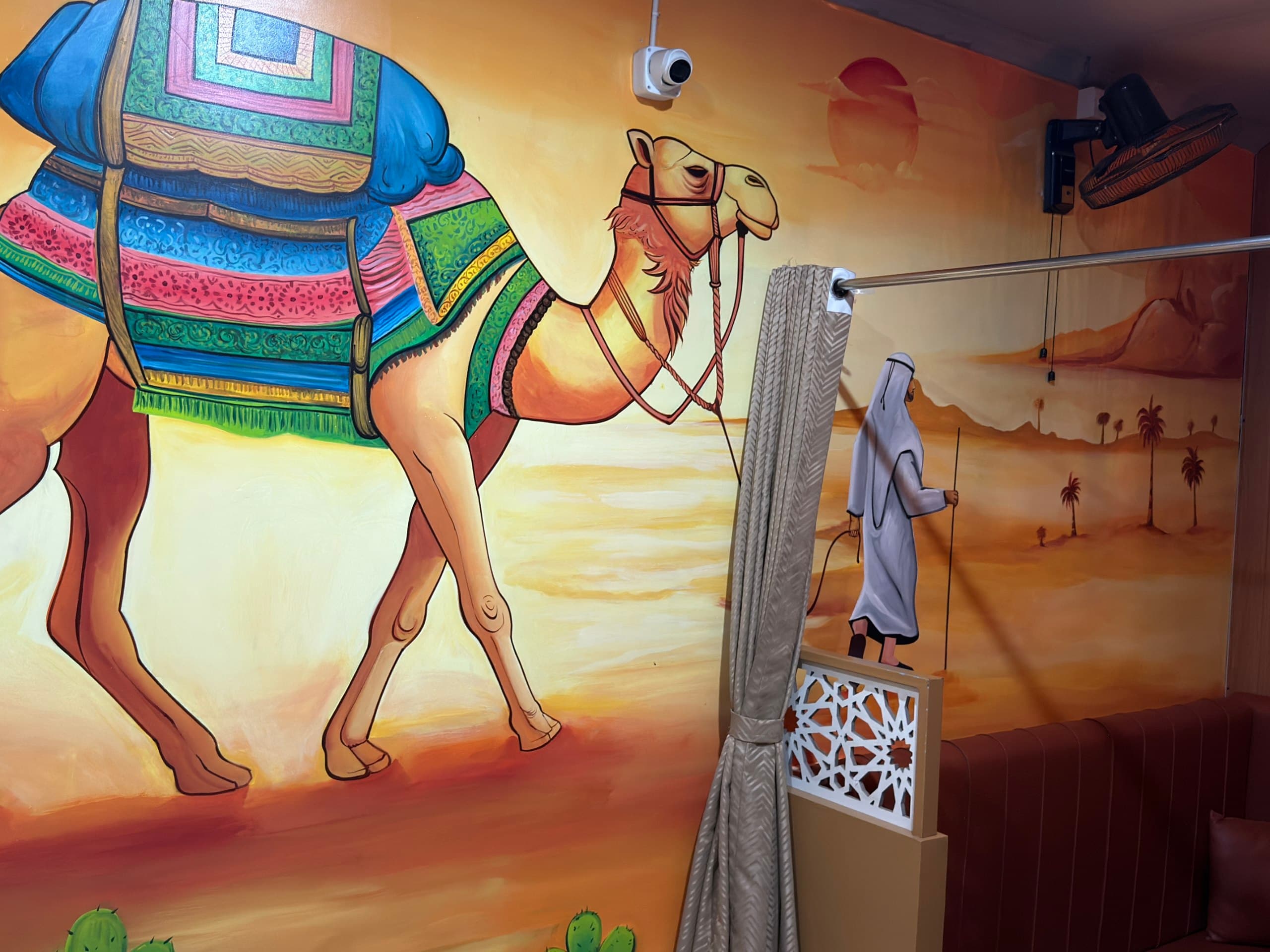 Camel mural seating section inside Habibi Arabian Mandi